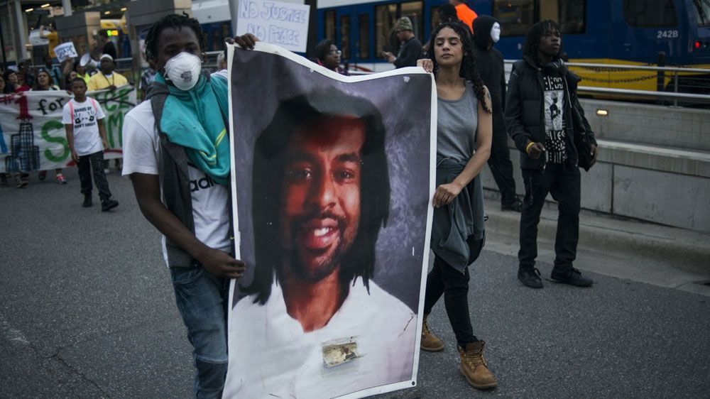 Protesters carry a portrait of Philando Castile on June 16, 2017 in St Paul, Minnesota. Protests erupted in Minnesota after Officer Jeronimo Yanez was acquitted on all counts of shooting and killing Philando Castile