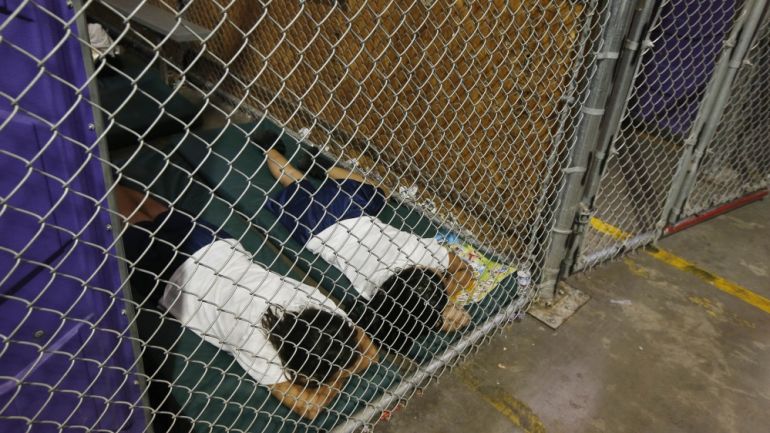 Two female detainees sleep in a holding cell at the US Customs and Border Protection Nogales Placement Center in Nogales, Arizona, in this June 18, 2014 file photo
