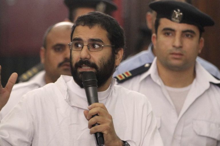 Activist Alaa Abdel Fattah speaks in front of a judge at a court during his trial in Cairo