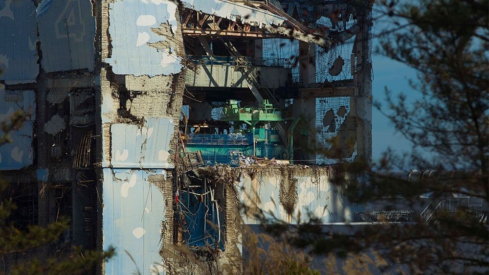 The Unit 4 reactor building of the crippled Fukushima Dai-ichi nuclear power station seen through a bus window eight months after the 2011 disaster.