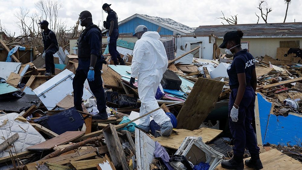 Police officers search for the dead in the destroyed Mudd neighbourhood after Hurricane Dorian hit the Abaco Islands in Marsh Harbour, Bahamas