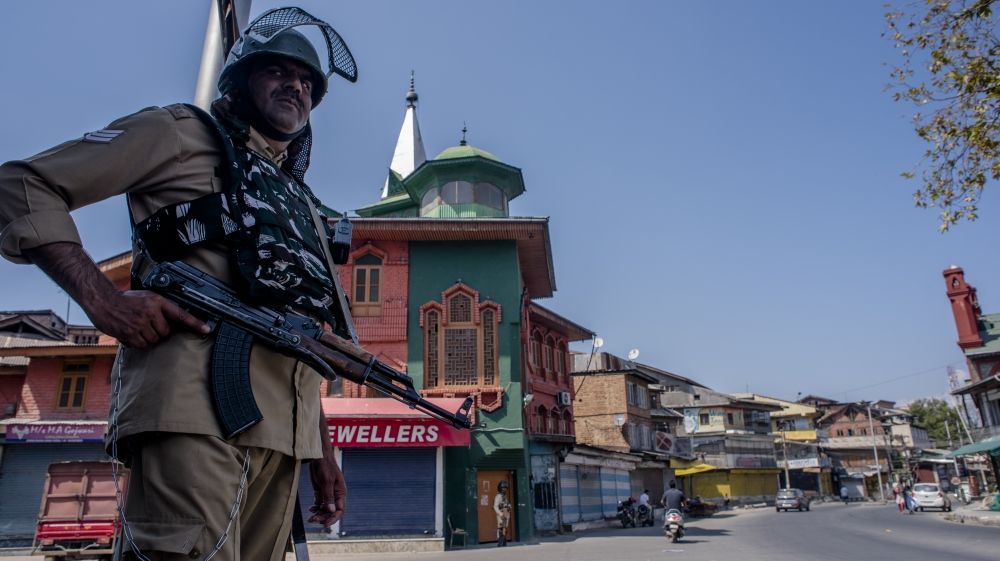 An Indian paramilitary trooper stands guard in the commercial hub of the old city of Srinigar after India revoked the autonomy status of Jammu and Kashmir and imposed restrictions on people living there.
