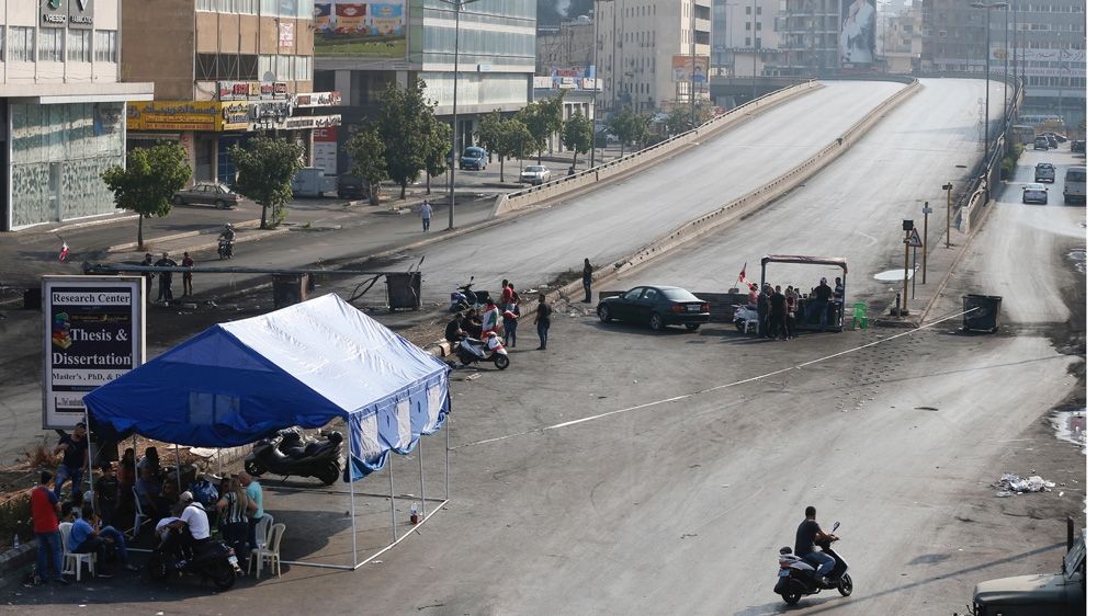 Barricades set up by demonstrators block a main road in Dora