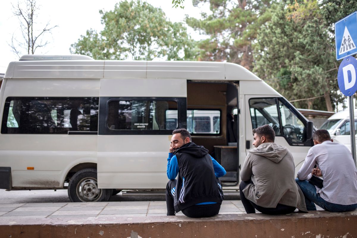 Empty buses wait to be filled with Syrian families exiting the Karkamis border crossing