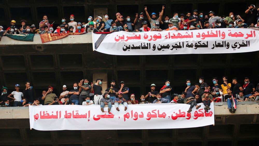 Demonstrators display a banner that reads ‘Mercy and Immortality for the Martyrs of the October revolution shame on the government of corrupt criminals’ and ‘No homeland no work’ during a protest in Baghdad