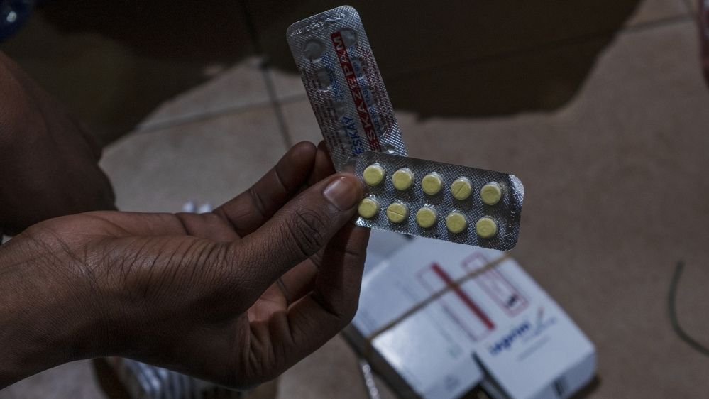 A policeman shows some of the drugs he has seized in Niamey, Niger