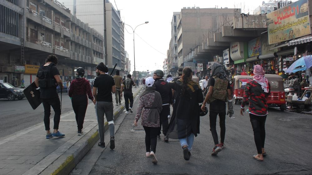 A group of young men and women walk from Tahrir Square to Rasheed Street and Ahrar Bridge