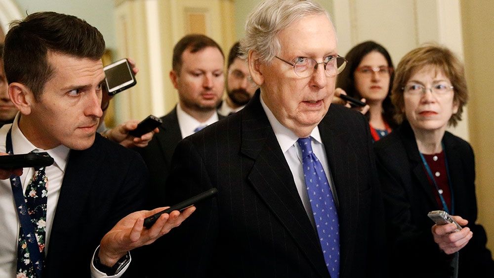 Senate Majority Leader Mitch McConnell speaks with reporters after walking off the Senate floor
