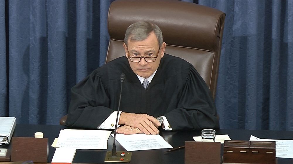 The presiding officer, Chief Justice of the United States John Roberts listens