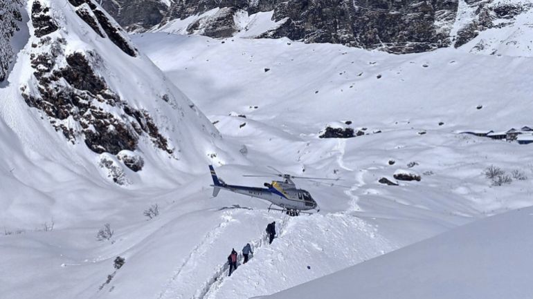 In this January 18, 2020 photo, trekkers are being rescued in a helicopter a day after an avalanche hit Mount Annapurna trail in Nepal