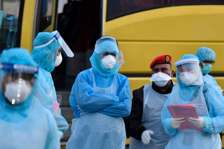 This handout photo taken and released by Malaysia''s Ministry of Health shows health officials in protective suits at the Kuala Lumpur International Airport in Sepang, Malaysia, Tuesday, Feb. 4, 2020,