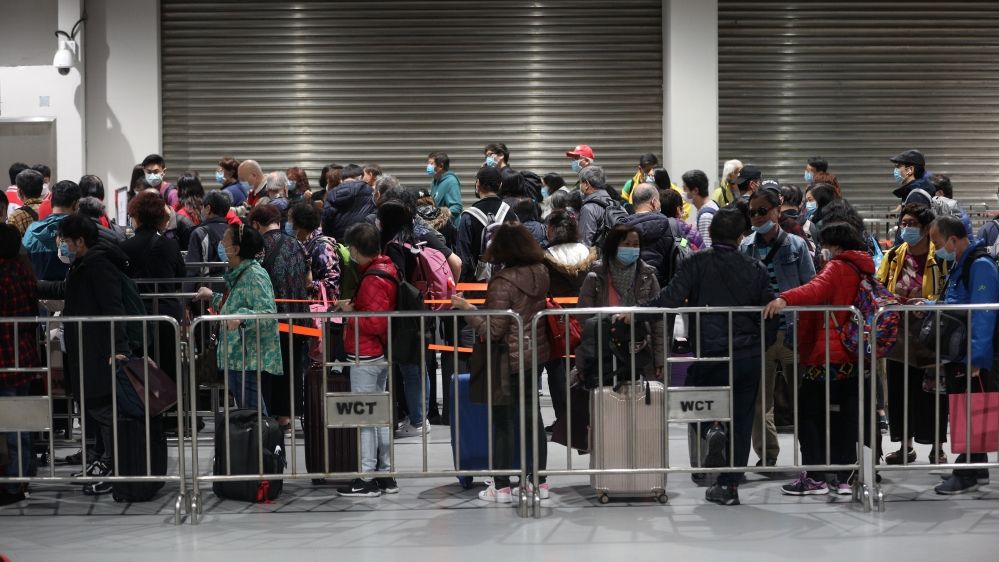 Passengers of the World Dream ship disembark on Sunday in Hong Kong after testing negative for coronavirus
