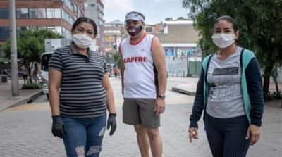 Milsen Solana with her husband, Oswaldo Naranjo and her aunt Maria Mendez pose in an empty street of Bogota