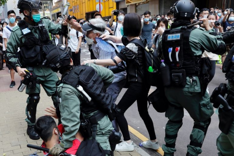 Hong Kong anti-government demonstrators scuffle with riot police