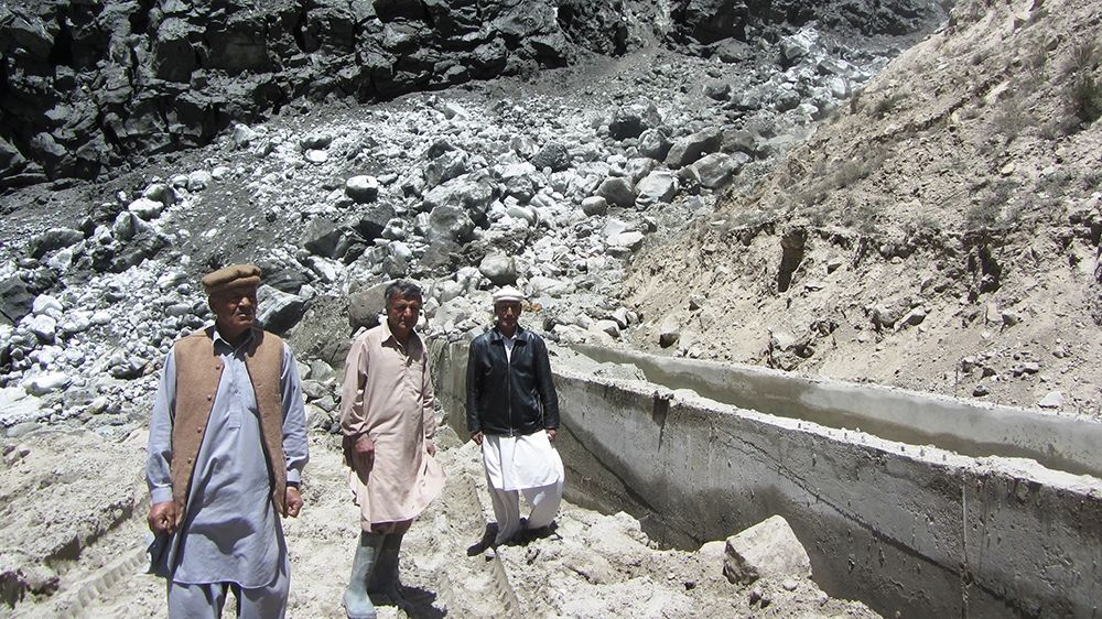 Local villagers check the movement of Shishper Glacier, as it advances in Hassanabad ravine, Pakistan