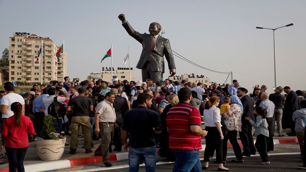 Palestinians take part in a ceremony to unveil a sculpture of anti-apartheid leader Nelson Mandela