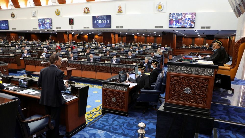 Anwar Ibrahim, left, speaks in the Malaysian Parliament on July 13