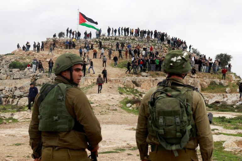 Israeli soldiers stand guard