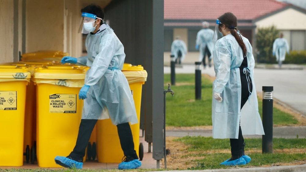 Medical staff dispose of clinical waste at an aged care facility experiencing an outbreak of the coronavirus disease in Melbourne