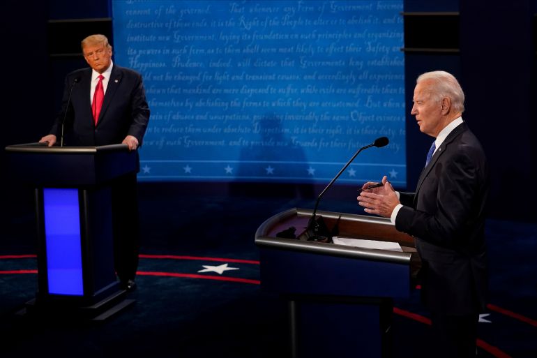 Biden answers a question as Trump listens during the second and final presidential debate