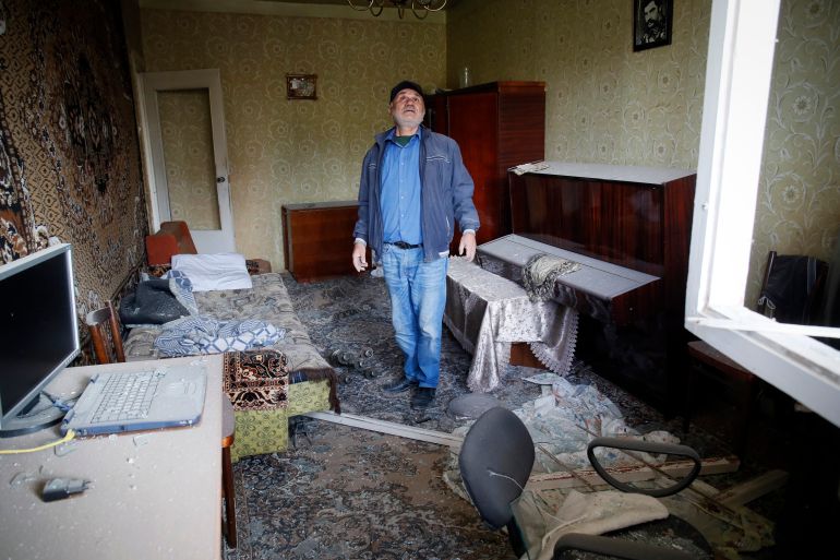 Eduard Chechyan examines the damage in his flat after shelling allegedly by Azerbaijan’s artillery during a military conflict in Stepanakert, Nagorno-Karabakh, October 10, 2020 [AP Photo]