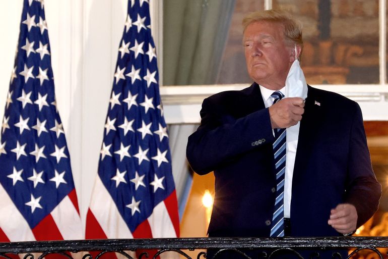 Donald Trump removes his face mask