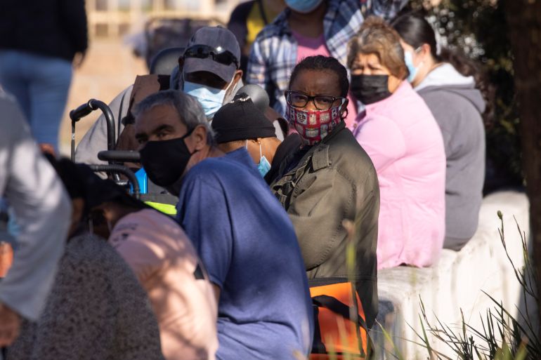 People wait in line as the Los Angeles Regional Food Bank distributes food outside a church amid the outbreak of the coronavirus in Los Angeles, California