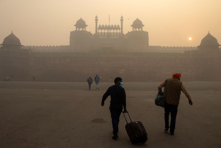 People arrive at the Red Fort on a smoggy morning in Delhi, India, November 10, 2020