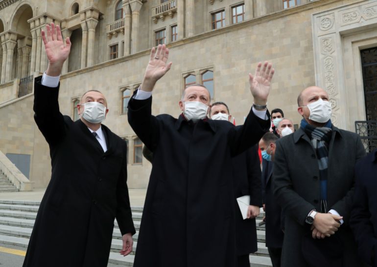 Presidents Erdogan of Turkey and Aliyev of Azerbaijan greet people during a military parade to mark victory in the Nagorno-Karabakh conflict, in Baku, Azerbaijan, on December 10, 2020