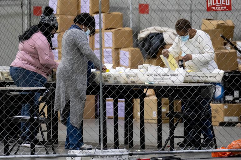 Election workers in Fulton County, Georgia process absentee ballots for the US Senate runoff election in Georgia