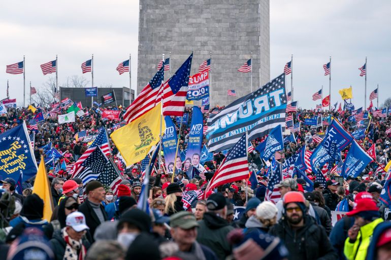 With the Washington Monument in the background, people attend a rally in support of President Donald Trump before rioters breached the US Capitol