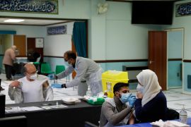 People receive the Oxford-AstraZeneca COVID vaccine at the Al-Abbas Islamic Centre, which has been converted into a temporary vaccination centre in Birmingham, central England on January 21, 2021 [Darren Staples/AFP]