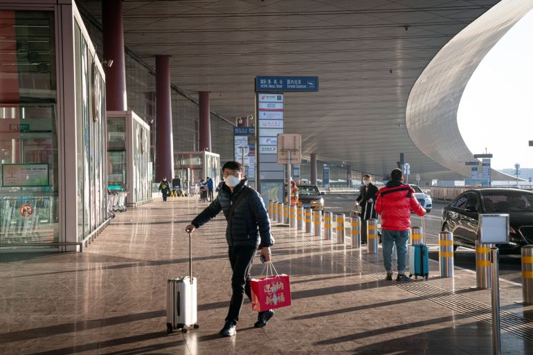 A traveler arrives at Beijing Capital International Airport ahead of Lunar New Year which starts on February 11