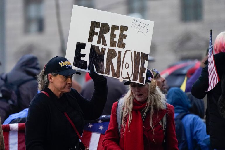 People hold a sign reading ‘Free Enrique’ in reference to Proud Boys leader Henry ‘Enrique’ Tarrio on January 5, 2021, in Washington, the day before the deadly Capitol riot