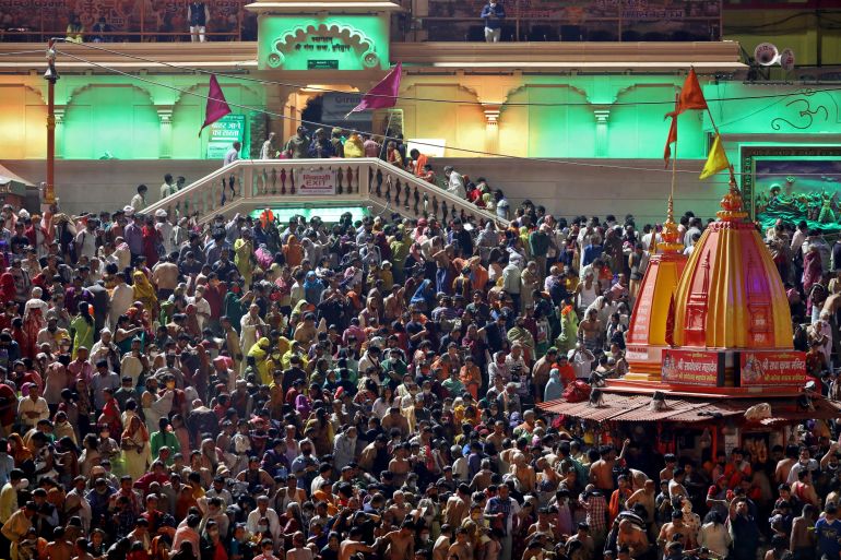 Hindu devotees gather to take a holy dip in the Ganges river during the Kumbh Mela