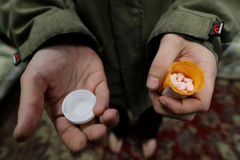 Jon Combes holds his bottle of buprenorphine, a medicine that prevents withdrawal sickness in people trying to stop using opiates, as he prepares to take a dose in a clinic in Olympia, Washington, in November 2019