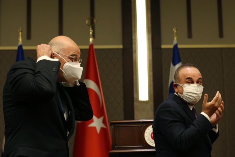 Turkish Foreign Minister Mevlut Cavusoglu, right, walks with Greek Foreign Minister Nikos Dendias, left, following their joint media statement after their meeting in Ankara, Turkey on April 15, 2021