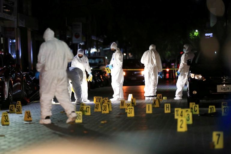 Police officers inspect the area after a blast outside Nasheed’s house in Male [Police Service via Reuters]