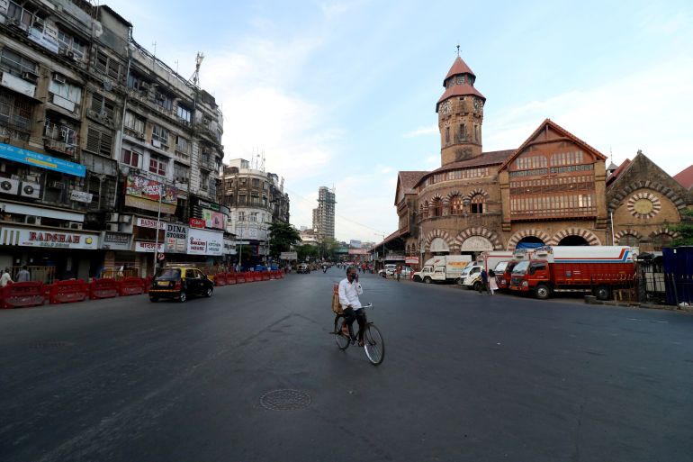 A man rides his bicycle during a lockdown to limit the spread of COVID-19 in Mumbai