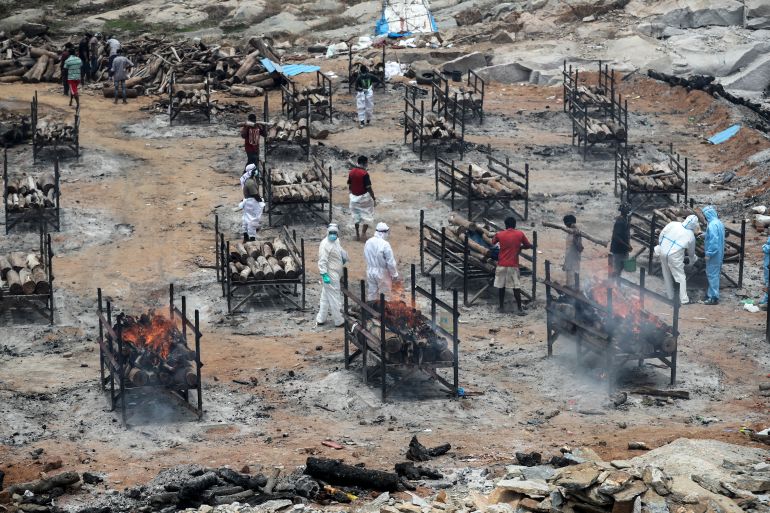 Bodies of people who died of COVID-19 are cremated at an open crematorium on the outskirts of Bengaluru, Karnataka state, India, Wednesday, May 12, 2021.