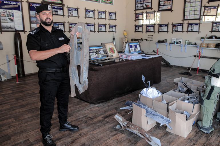 Captain Mohammed Meqdad shows the remnants of Israeli warheads that exploded on the Abu al-Ouf building during an attack on Wehda Street