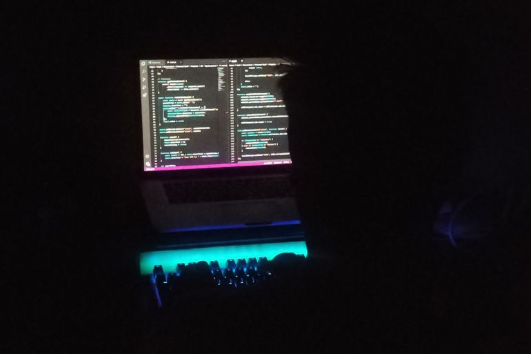 Ali Atayee working on his laptop during one of the power blackouts in Kabul