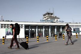 Travellers exit the Hamid Karzai International Airport in Kabul [File: S Sabawoon/EPA-EFE]