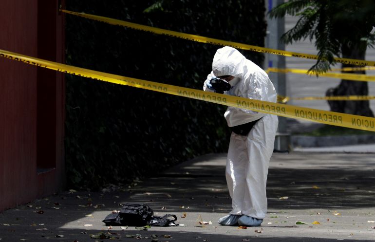 A forensic technician taking a photo of a flak jacket at a crime scene following an assassination attempt of Mexico City’s police chief Omar Garcia Harfuch, in the upscale neighbourhood of Lomas de Chapultepec, in Mexico City, Mexico on June 26, 2020