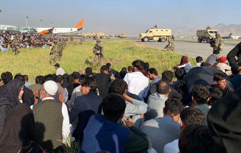 US soldiers stand guard along a perimeter at the international airport in Kabul, Afghanistan