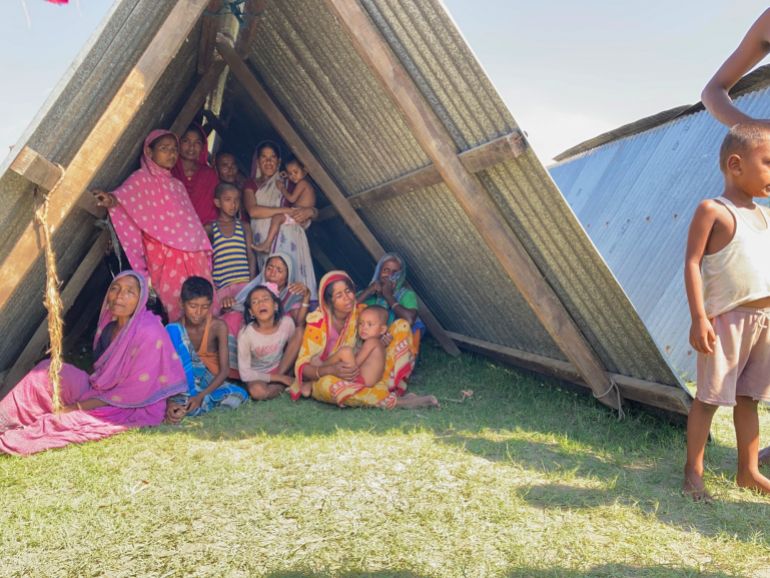 Mainal Haq’s Family, his wife Mumtaz Begum (right), holding a child, in their small two tin sheet settlement
