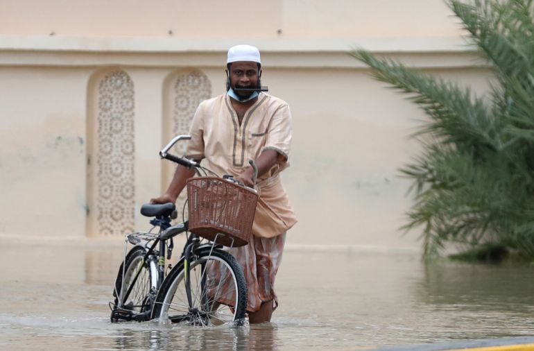 A man wades through a flooded street in Oman’s capital Muscat