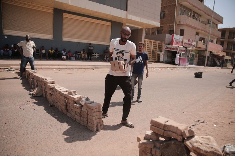 People set up a barricade during a protest in Khartoum, Sudan