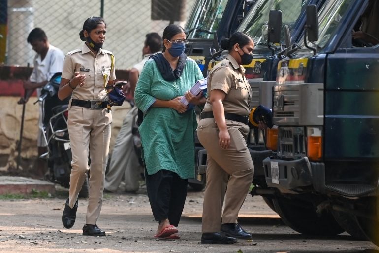 Police escort activist and lawyer Sudha Bharadwaj towards a van in Mumbai