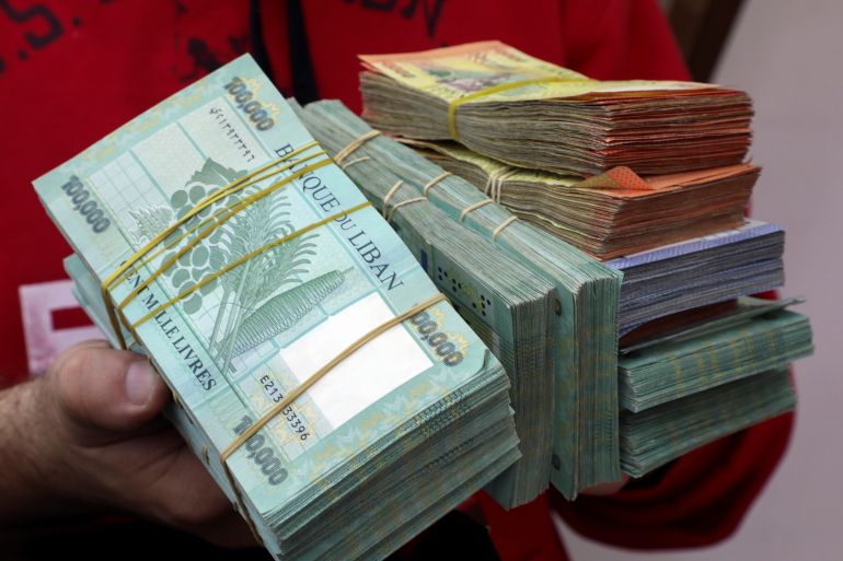A money exchange vendor displays Lebanese pound banknotes at his shop in Beirut, Lebanon,